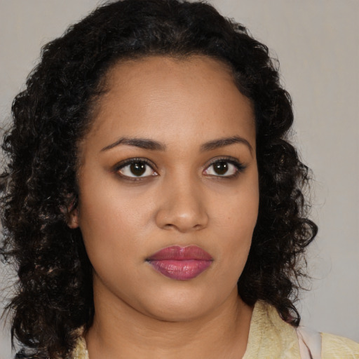 Joyful black young-adult female with medium  black hair and brown eyes
