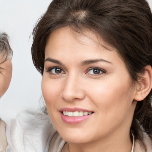 Joyful white young-adult female with medium  brown hair and brown eyes