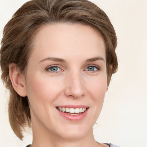 Joyful white young-adult female with medium  brown hair and blue eyes