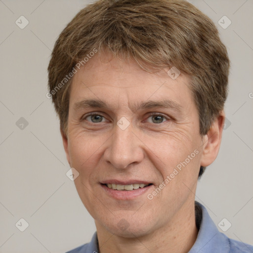 Joyful white adult male with short  brown hair and grey eyes