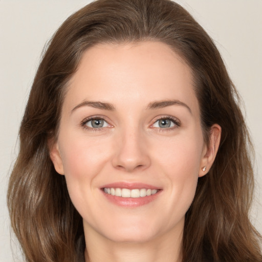 Joyful white young-adult female with long  brown hair and brown eyes