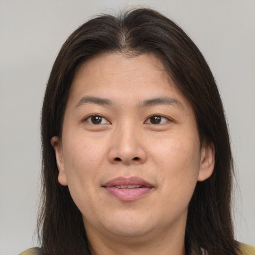 Joyful asian adult female with medium  brown hair and brown eyes