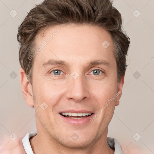 Joyful white adult male with short  brown hair and grey eyes