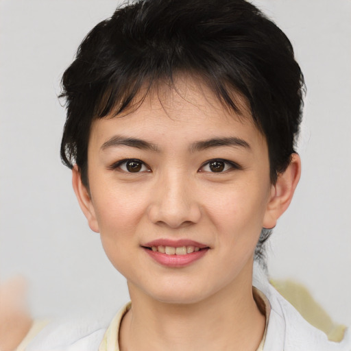 Joyful asian young-adult female with short  brown hair and brown eyes