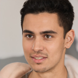 Joyful white young-adult male with short  black hair and brown eyes