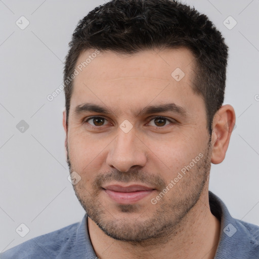 Joyful white young-adult male with short  black hair and brown eyes