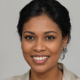 Joyful latino young-adult female with medium  brown hair and brown eyes