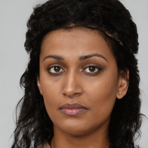 Neutral black young-adult female with long  brown hair and brown eyes