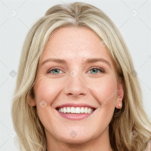 Joyful white young-adult female with long  brown hair and blue eyes