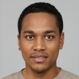 Joyful black young-adult male with short  black hair and brown eyes