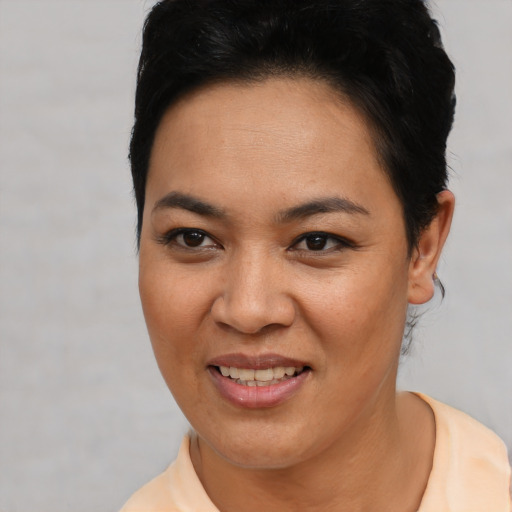 Joyful asian young-adult female with short  black hair and brown eyes