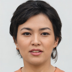 Joyful asian young-adult female with medium  brown hair and brown eyes