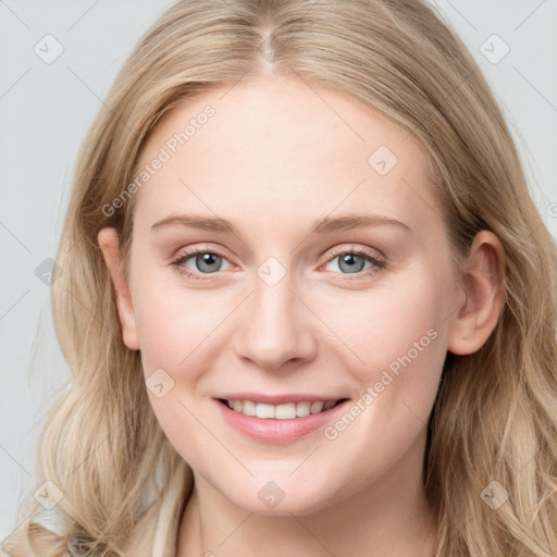 Joyful white young-adult female with long  brown hair and blue eyes