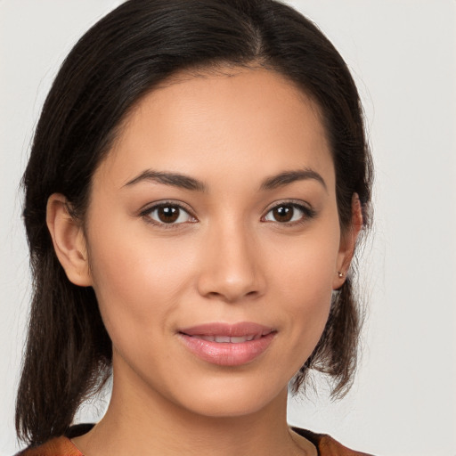 Joyful latino young-adult female with medium  brown hair and brown eyes