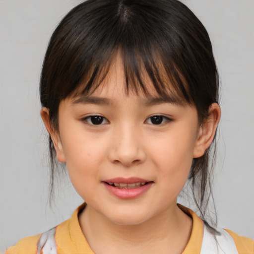 Joyful asian child female with medium  brown hair and brown eyes