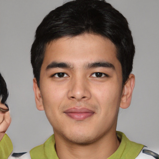 Joyful asian young-adult male with short  black hair and brown eyes