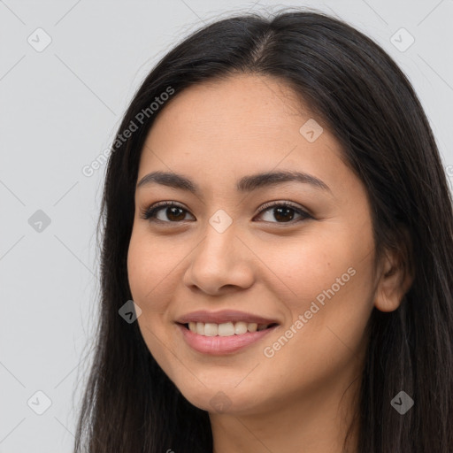 Joyful latino young-adult female with long  brown hair and brown eyes