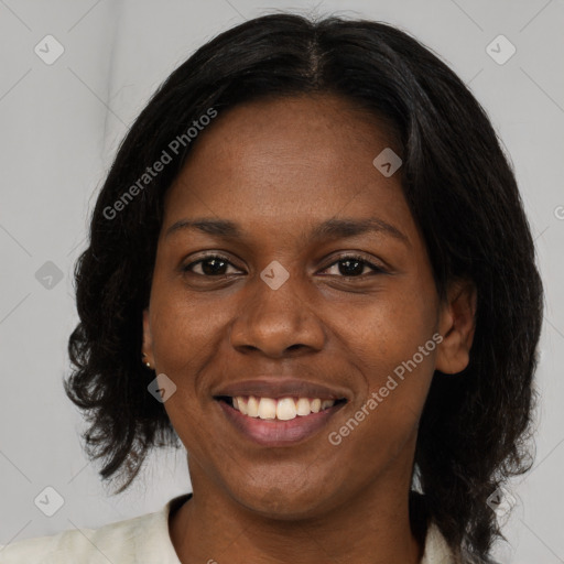 Joyful black young-adult female with medium  brown hair and brown eyes