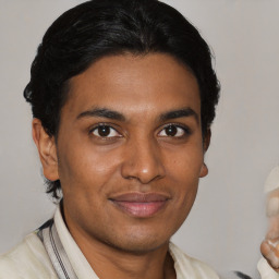 Joyful latino young-adult male with short  brown hair and brown eyes