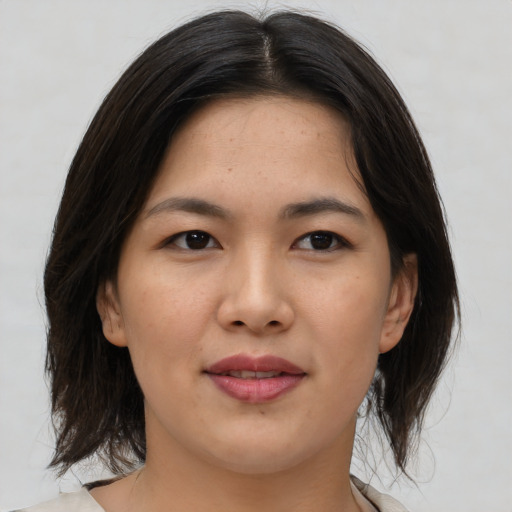 Joyful asian young-adult female with medium  brown hair and brown eyes