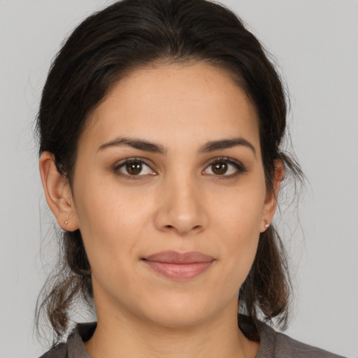 Joyful white young-adult female with medium  brown hair and brown eyes