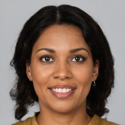 Joyful black young-adult female with medium  brown hair and brown eyes