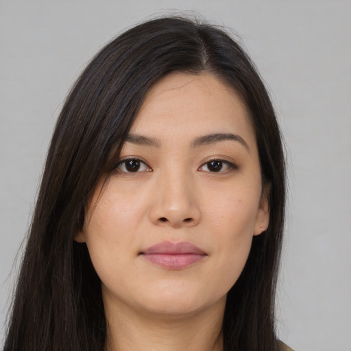 Joyful asian young-adult female with long  brown hair and brown eyes