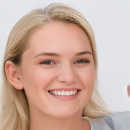 Joyful white young-adult female with long  brown hair and blue eyes