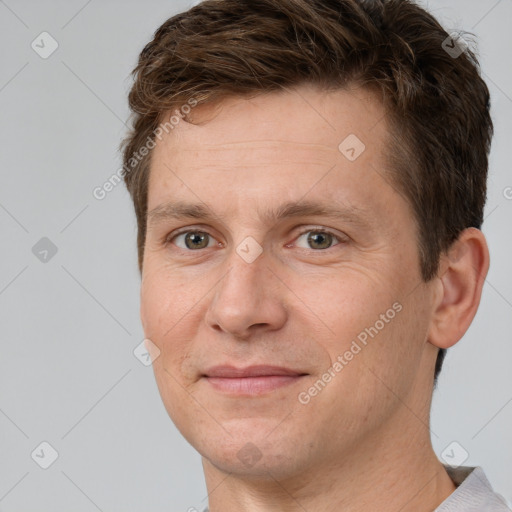 Joyful white adult male with short  brown hair and brown eyes