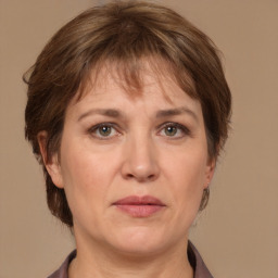 Joyful white adult female with medium  brown hair and grey eyes