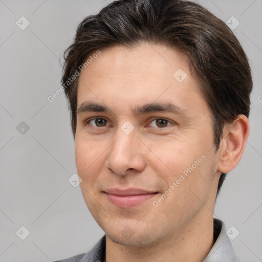 Joyful white adult male with short  brown hair and brown eyes