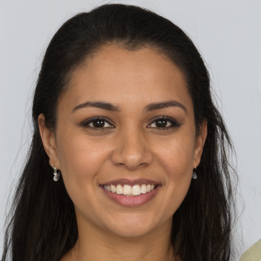 Joyful latino young-adult female with long  brown hair and brown eyes