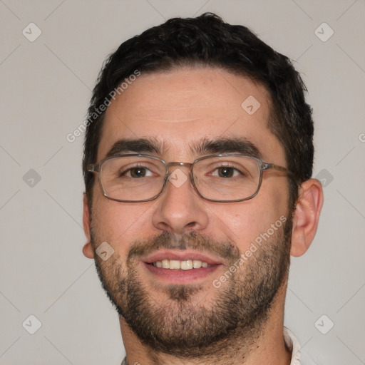 Joyful white young-adult male with short  black hair and brown eyes