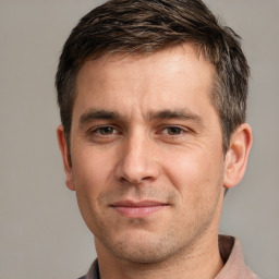 Joyful white adult male with short  brown hair and grey eyes