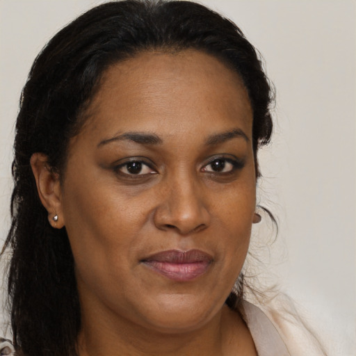Joyful black adult female with medium  brown hair and brown eyes