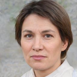 Joyful white adult female with medium  brown hair and brown eyes