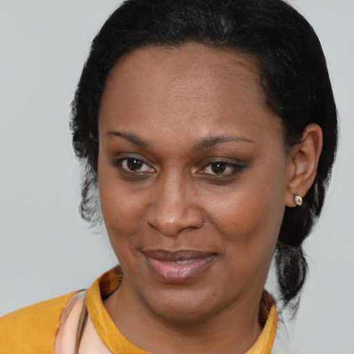 Joyful black adult female with short  brown hair and brown eyes