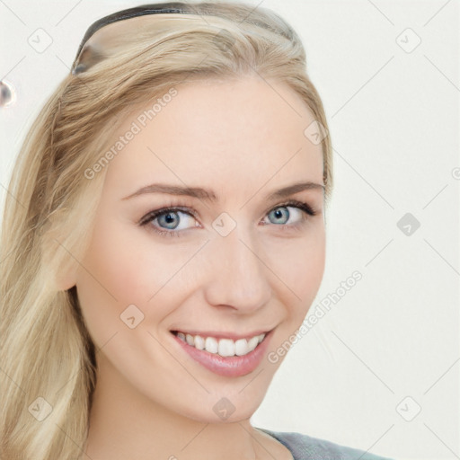 Joyful white young-adult female with long  brown hair and blue eyes