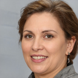 Joyful white adult female with medium  brown hair and brown eyes