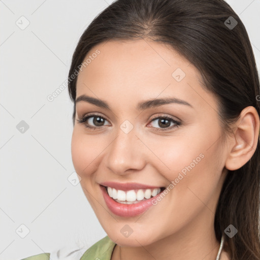 Joyful white young-adult female with long  brown hair and brown eyes