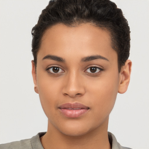 Joyful latino young-adult female with short  brown hair and brown eyes