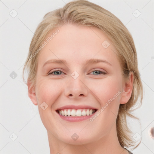 Joyful white young-adult female with medium  brown hair and blue eyes