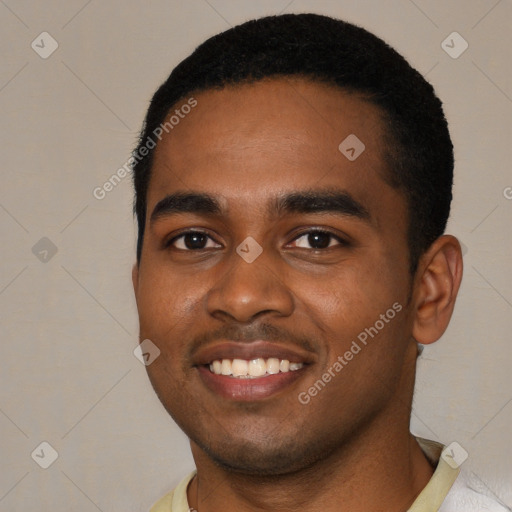 Joyful black young-adult male with short  black hair and brown eyes