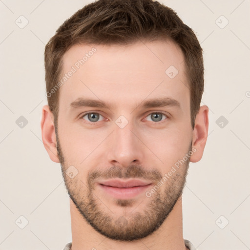 Joyful white young-adult male with short  brown hair and grey eyes