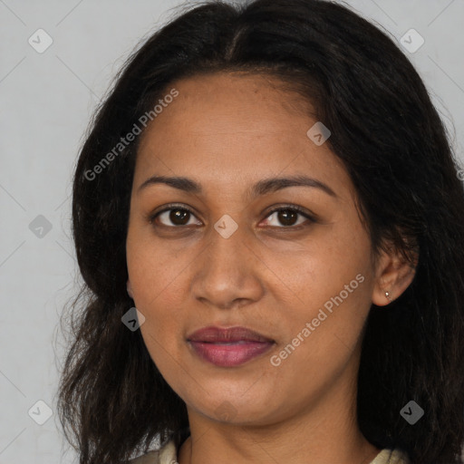 Joyful black young-adult female with long  brown hair and brown eyes