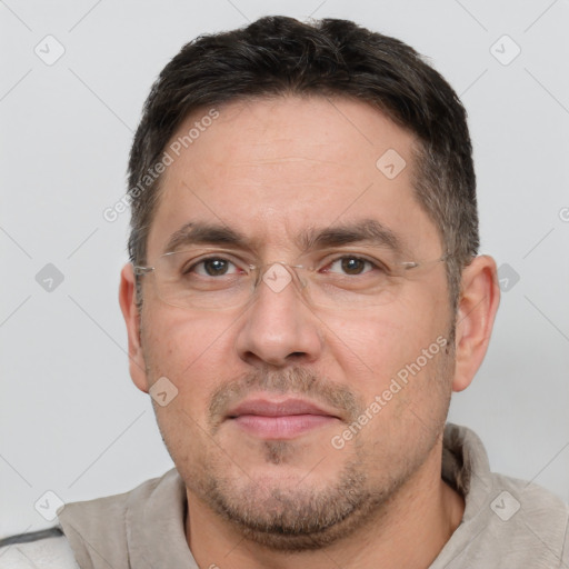 Joyful white adult male with short  brown hair and brown eyes