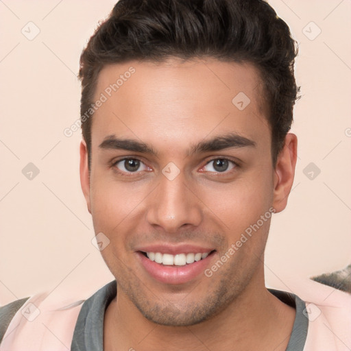 Joyful white young-adult male with short  brown hair and brown eyes