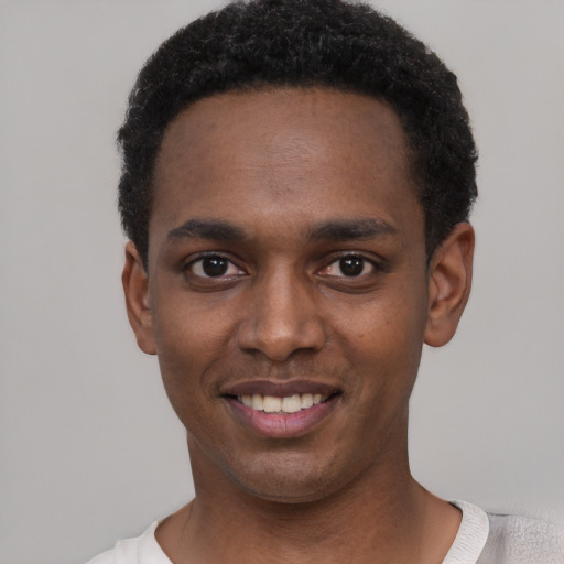 Joyful black young-adult male with short  black hair and brown eyes
