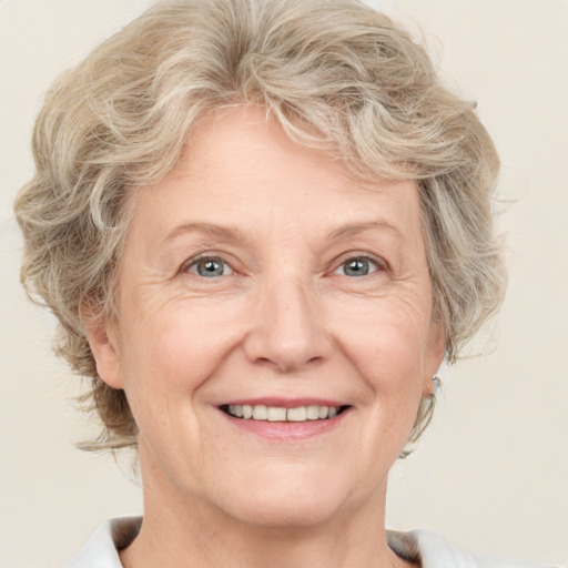 Joyful white adult female with medium  brown hair and blue eyes