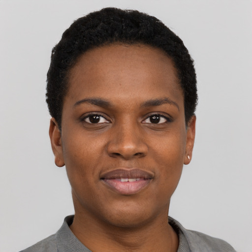 Joyful black young-adult female with short  black hair and brown eyes